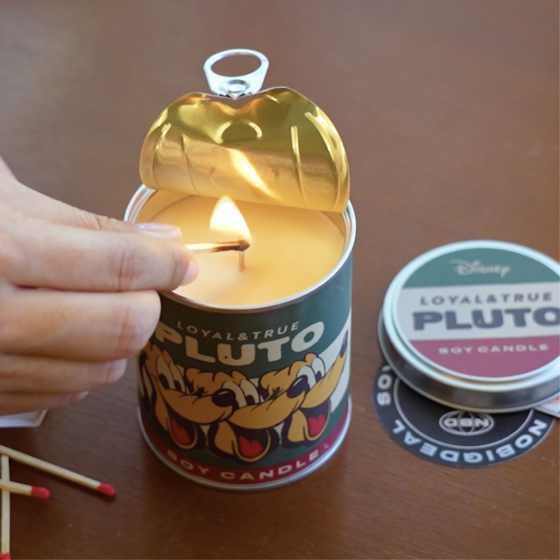 NOBIGDEAL Can Candle Disney soy candle pull-tab lid opened and lit with match