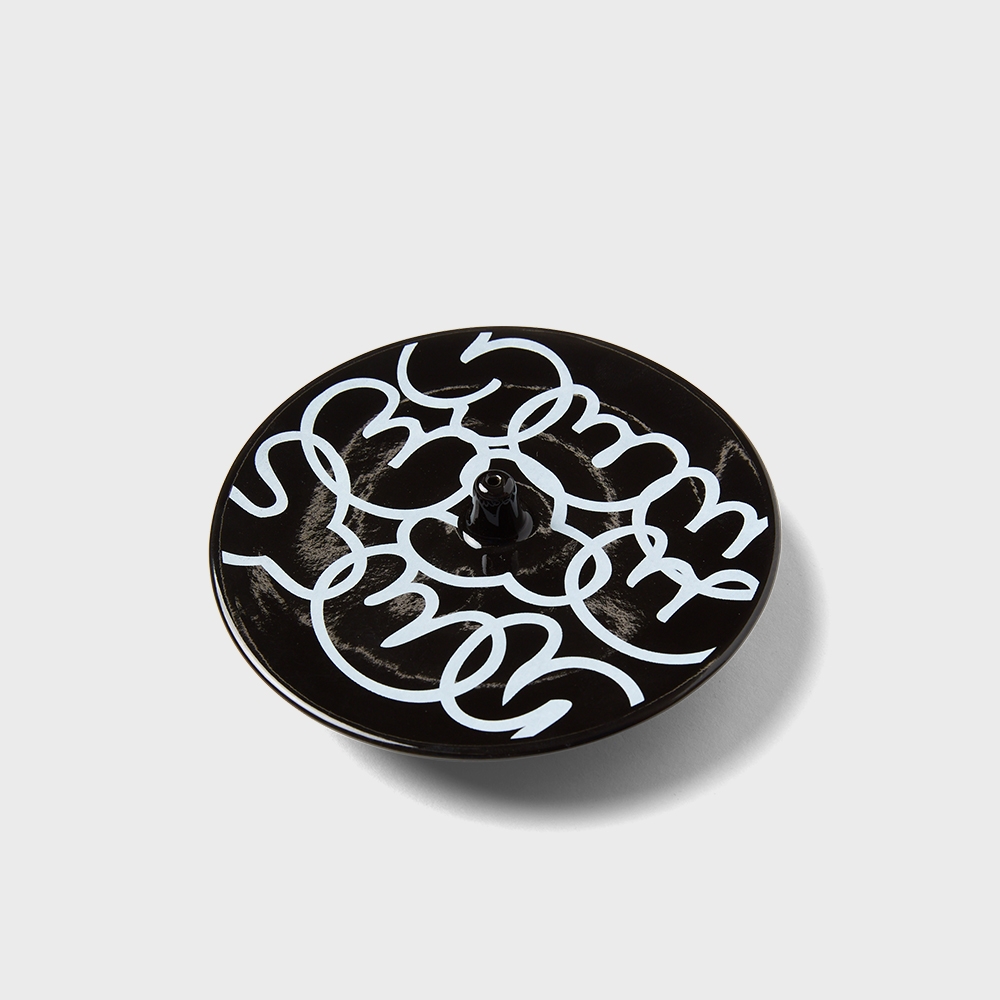 YESEYESEE C-logo Incense Holder Black angled view of glossy ceramic plate