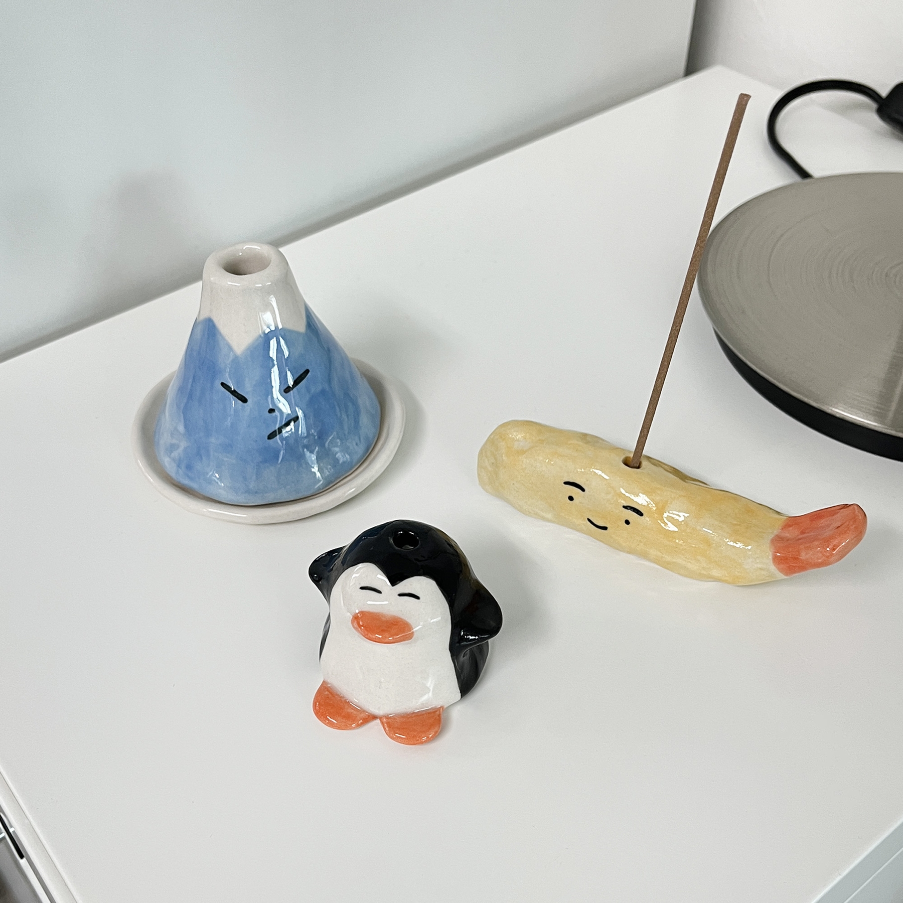 K-Lifestyle STEADINARY Fried Shrimp Incense Holder with incense stick, shown next to mountain and penguin holders