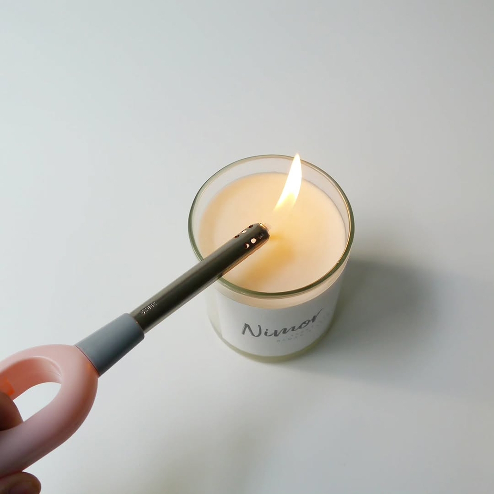 NIMOR Candle Lighter lighting a candle wick, how to use