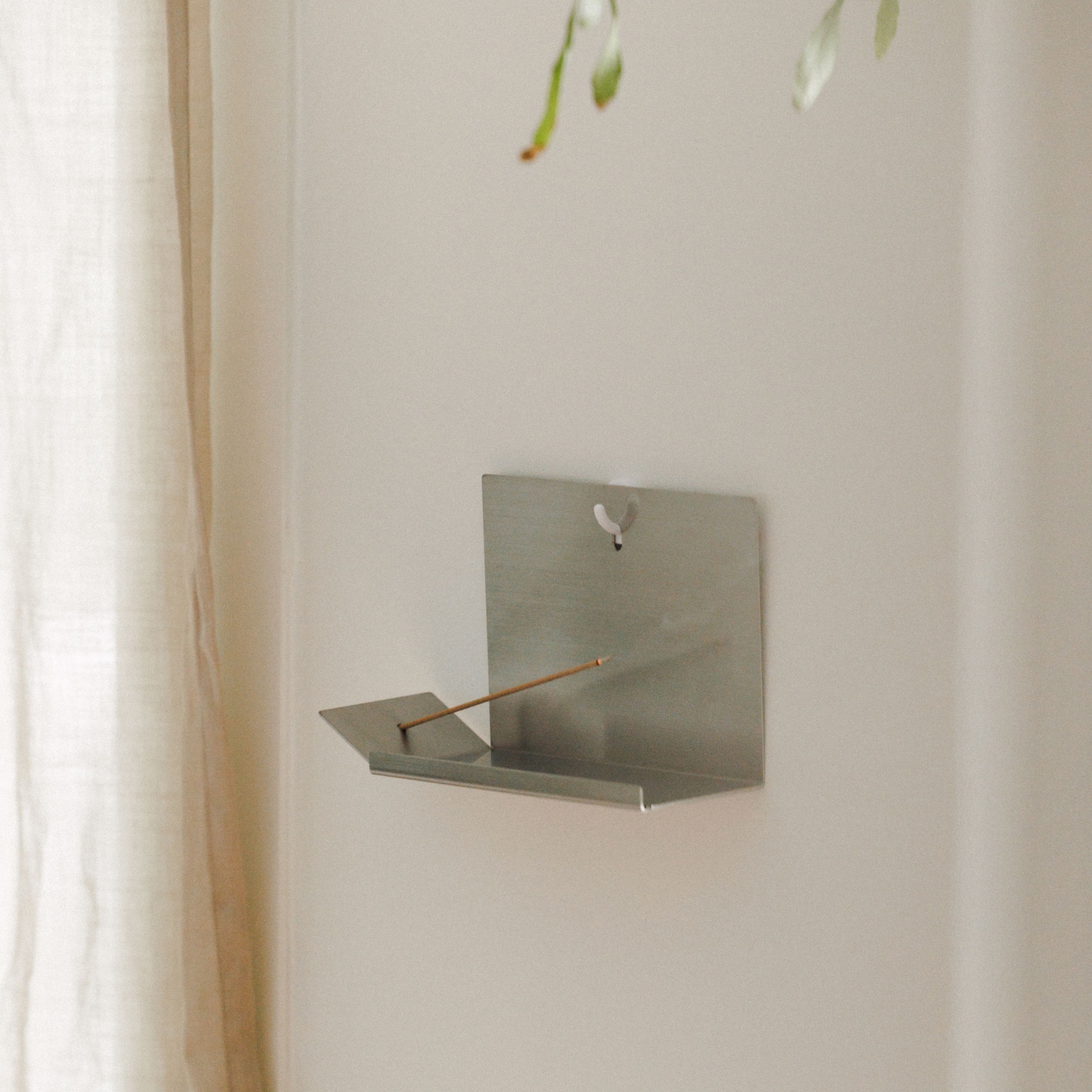wugo Hanging incense holder wall-mounted on a hook, side view with incense stick