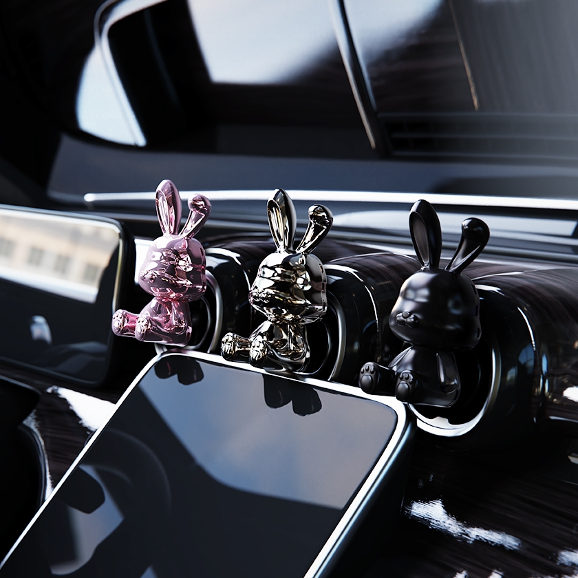 TIGER DASSLER British Bunny car air freshener on dashboard vents, pink, black silver and matt black in use