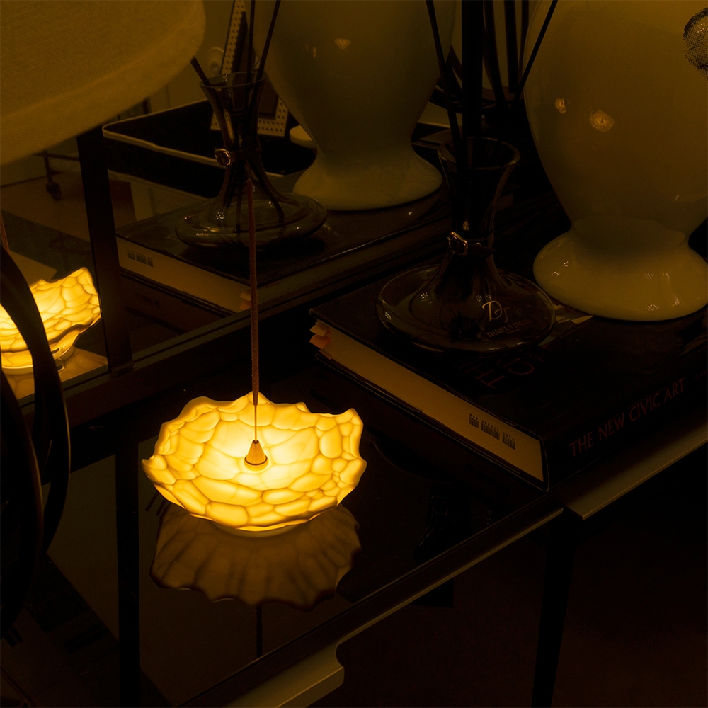 WOOSM Ceramic Mood Light Incense Holder petal design glowing with incense stick on side table
