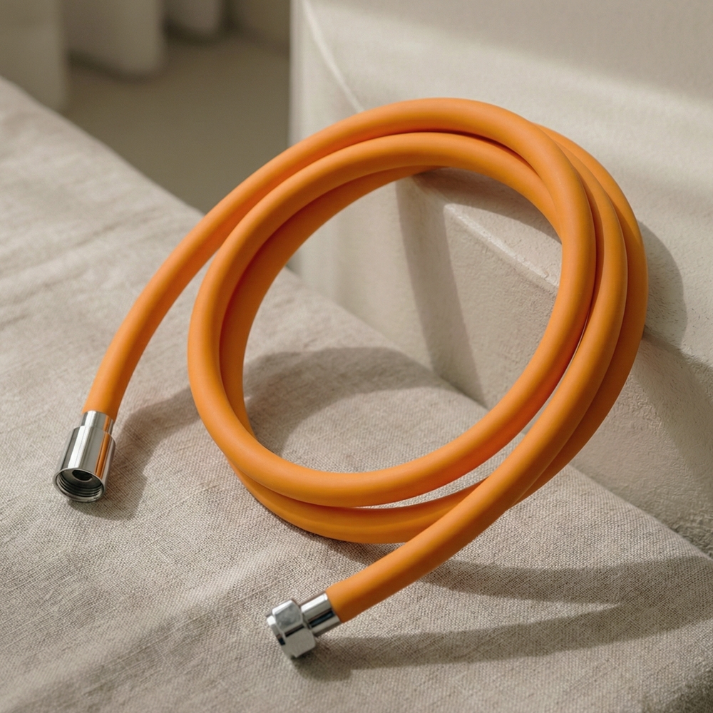 BATHTEM tube shower hose orange matte finish with chrome end fittings, coiled hose close-up