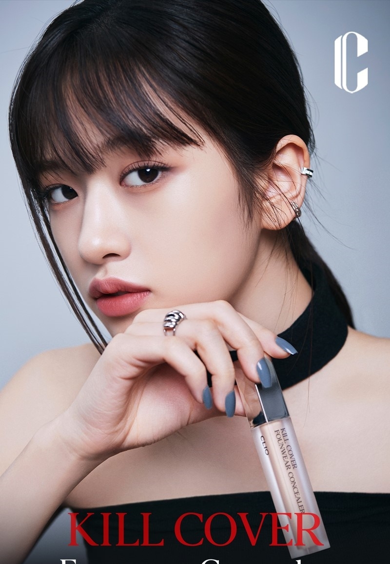 Clio Kill Cover Founwear Concealer 6g campaign banner on model holding tube