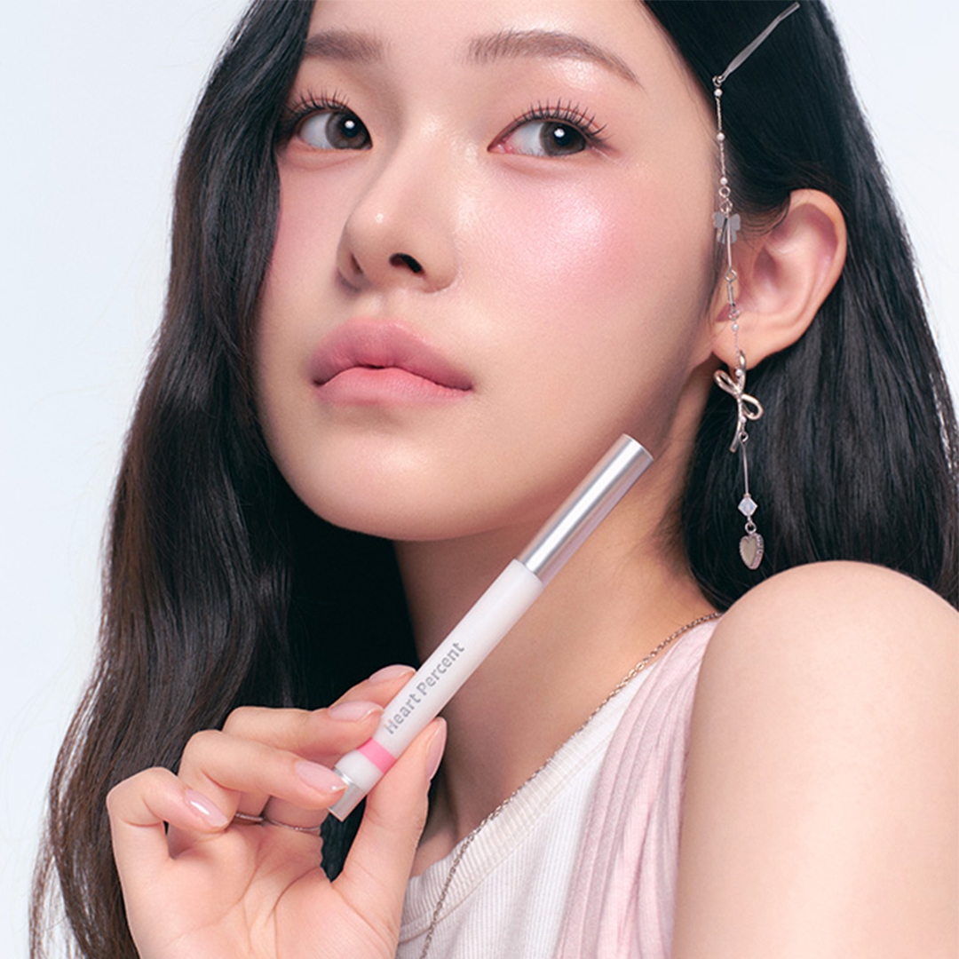 Heartpercent Dote on Mood Lineproof Lip Pencil on model lips, held in hand