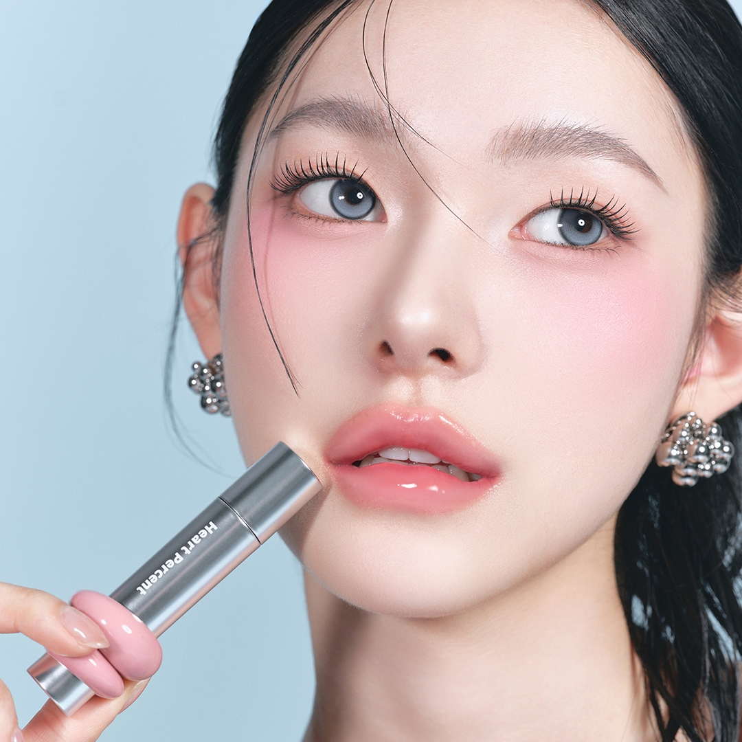 Heartpercent Dote on Mood One Way Glowy Tint glossy pink lips on model applying tint