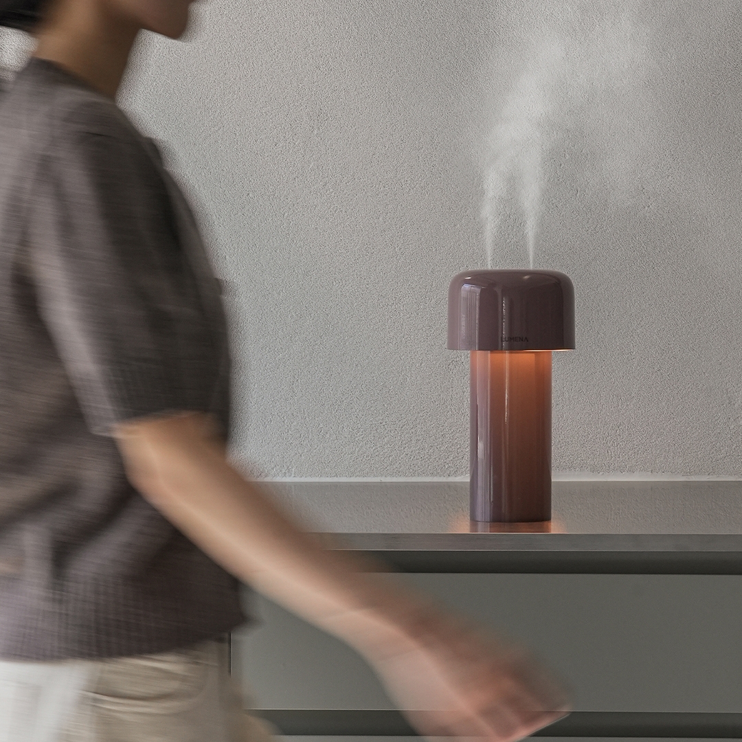 lumena MIST STAND burgundy humidifier lamp releasing mist on a shelf