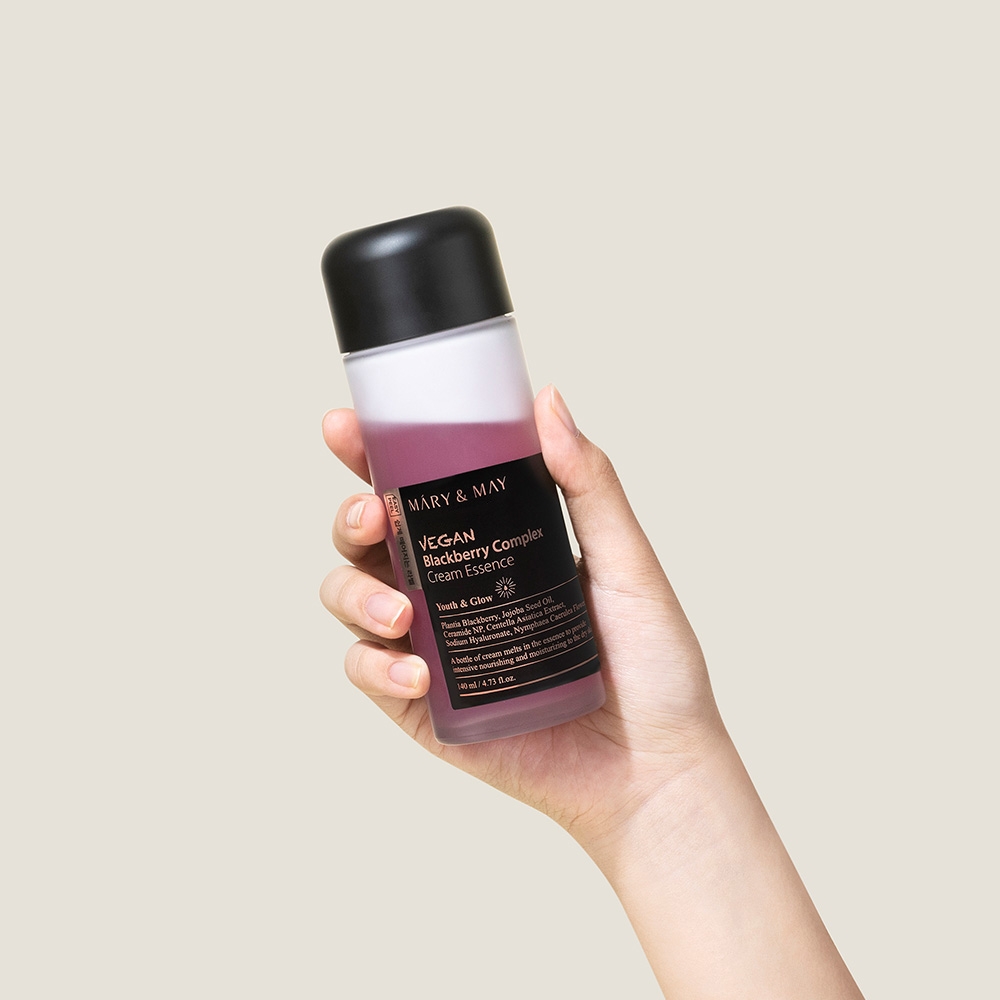 Mary&May Vegan Blackberry Complex Cream Essence 140ml bottle held in hand