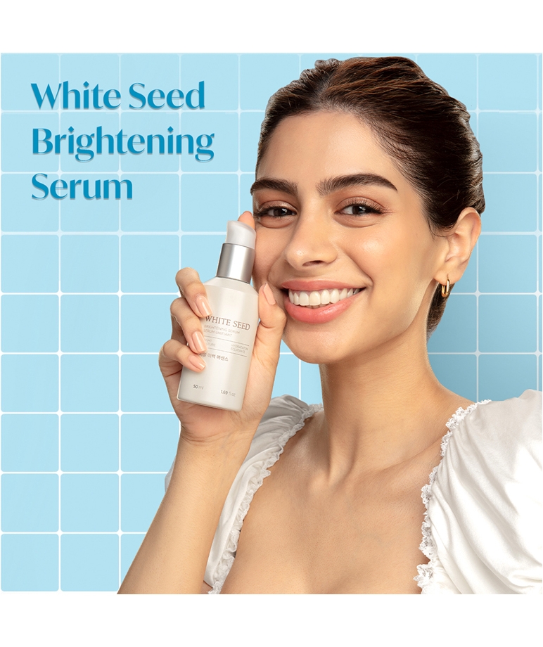 The Face Shop White Seed Brightening Serum 50ml held by model, front of bottle
