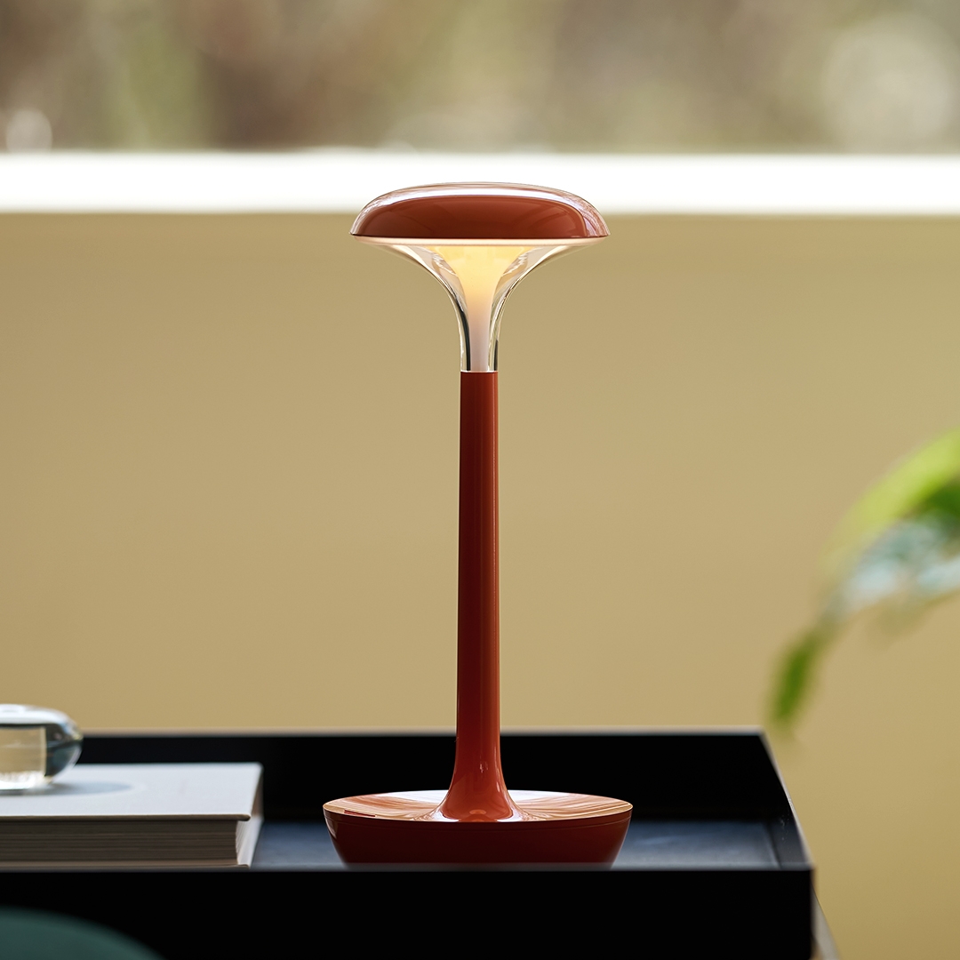 lumena SPACE ON PLUS table lamp Sun Orange without shade glowing on side table