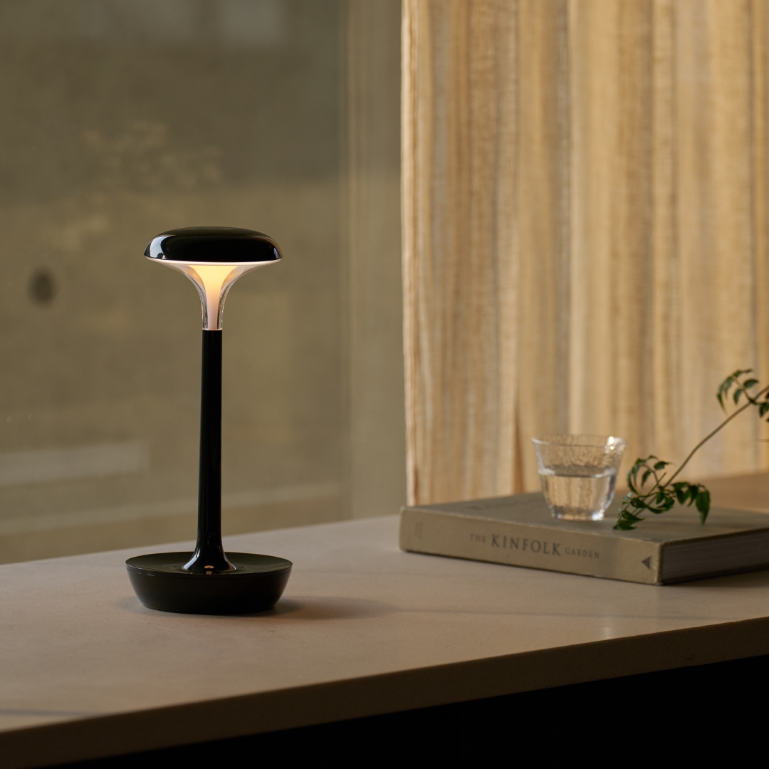 lumena SPACE ON PLUS table lamp dark finish lit on desk by window