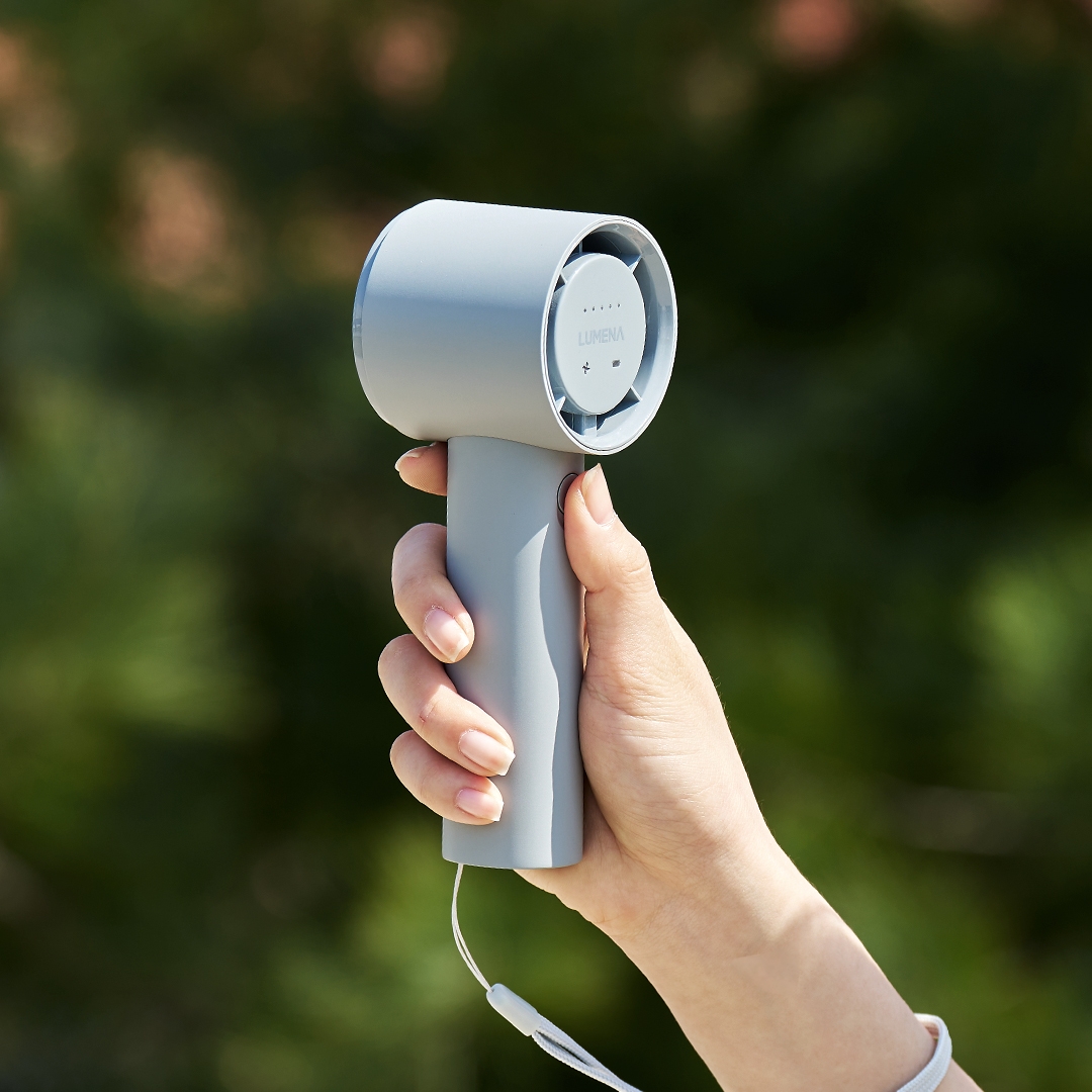 lumena FAN PRO JET handheld fan clipped to backpack strap